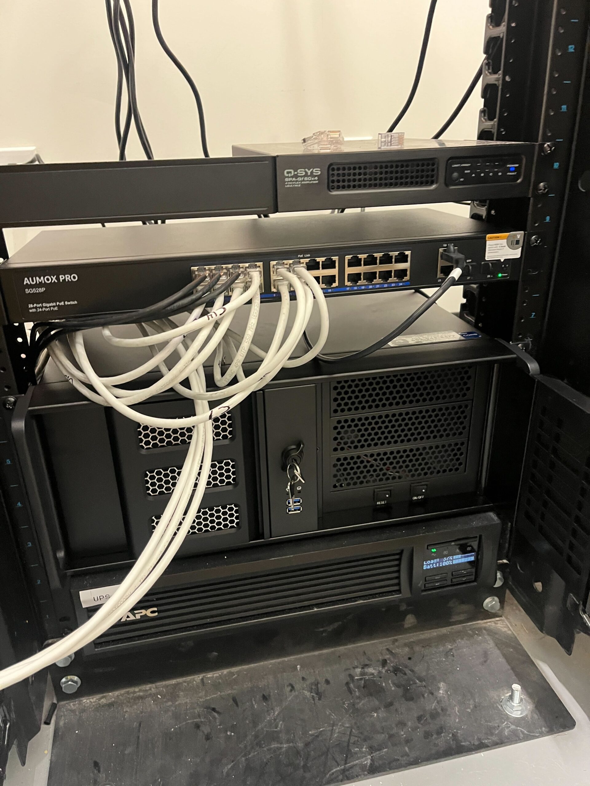 After-hours security monitoring headend: Digital Watchdog recording server in a rack with PoE switch and UPS